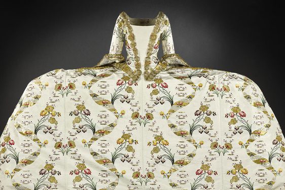 An extravagant gown with a wide skirt and complex pattern designs.