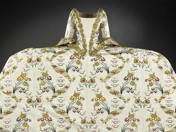 An extravagant gown with a wide skirt and complex pattern designs.