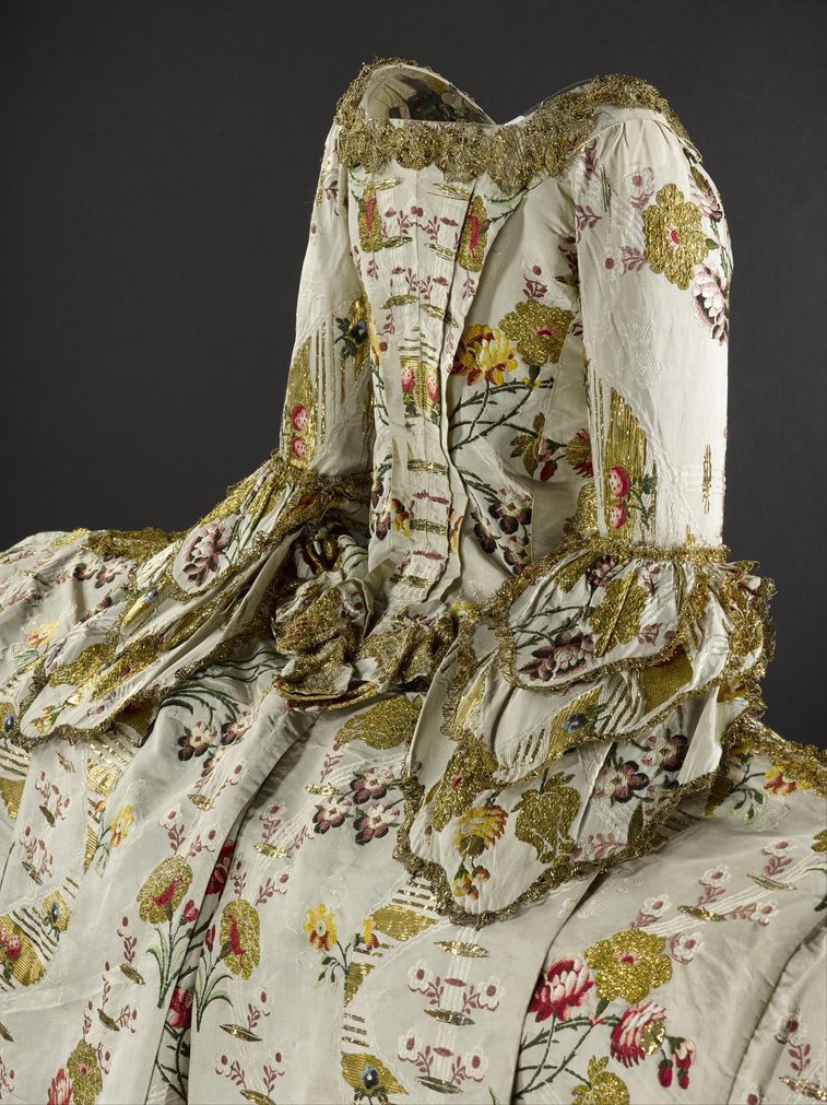 An extravagant gown with complex pattern designs.