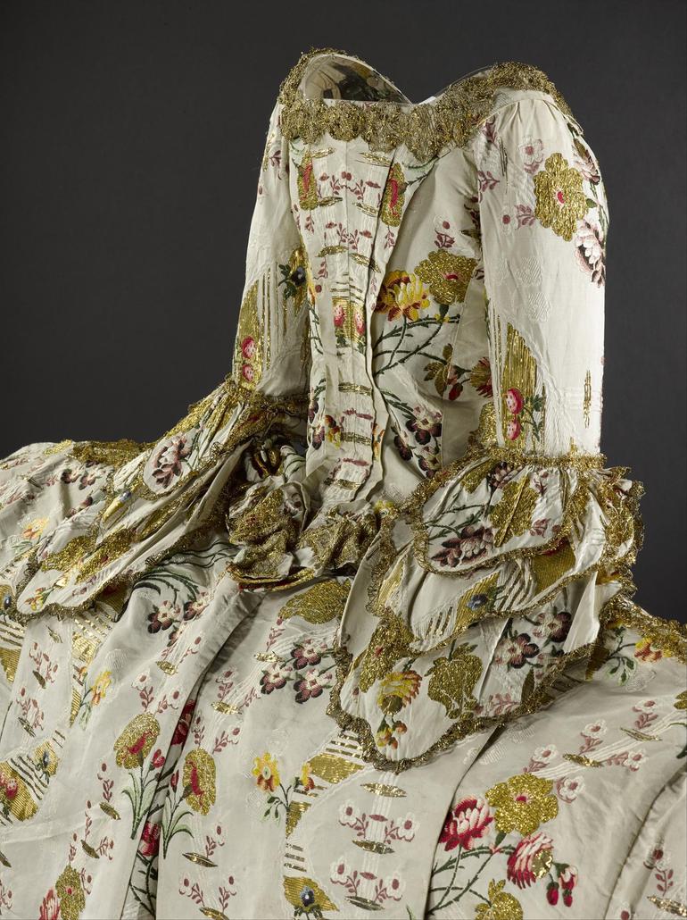 An extravagant gown with complex pattern designs.