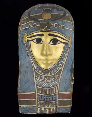 A mummy mask painted with hues of blue, red, and gold.