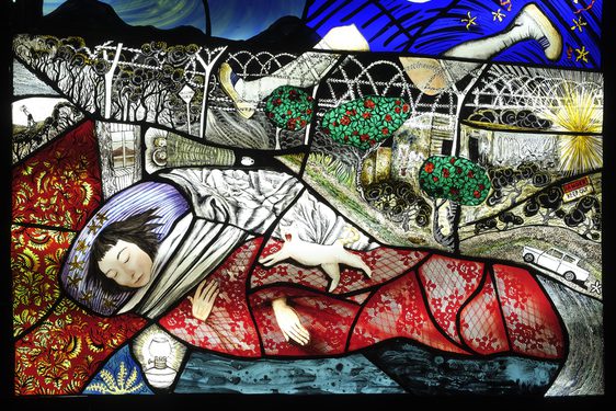 Painted glass portrait of a sleeping figure wrapped in a red lace patterned blanket. there are barbed wire fences in the background, a pair of running legs, and a tree, moon and stars on a night sky.