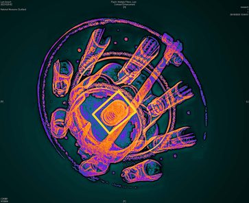 A coloured x ray of a raised round brooch.