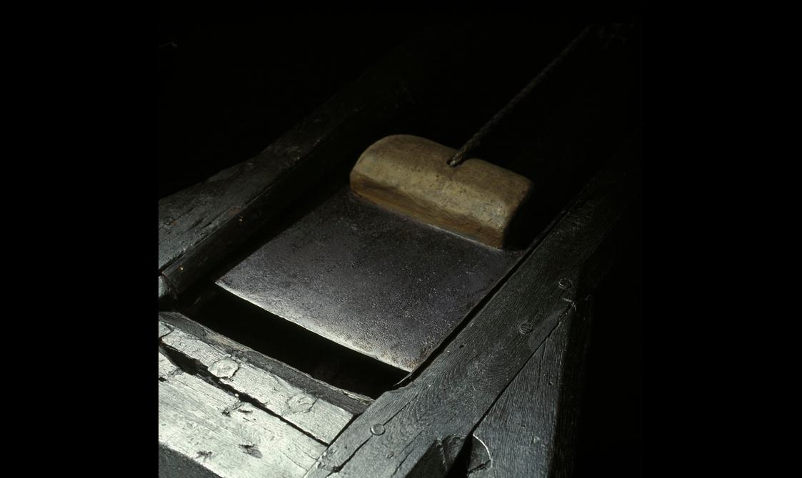 Side view of the blade of a wooden guillotine.