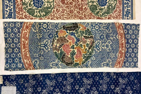 Three samples of colourful cotton cloths arranged horizontally. Each cloth has a different design common to cotton manufacturing in China.