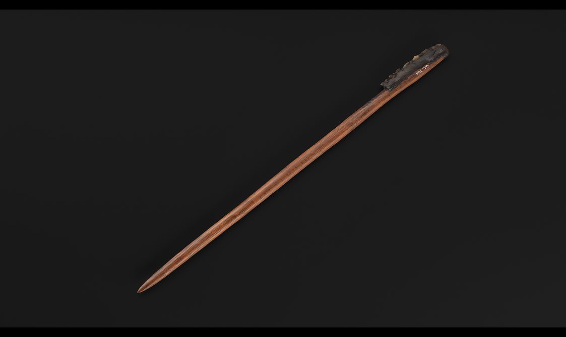 Piece of wood with small shards of glass fixed into one side