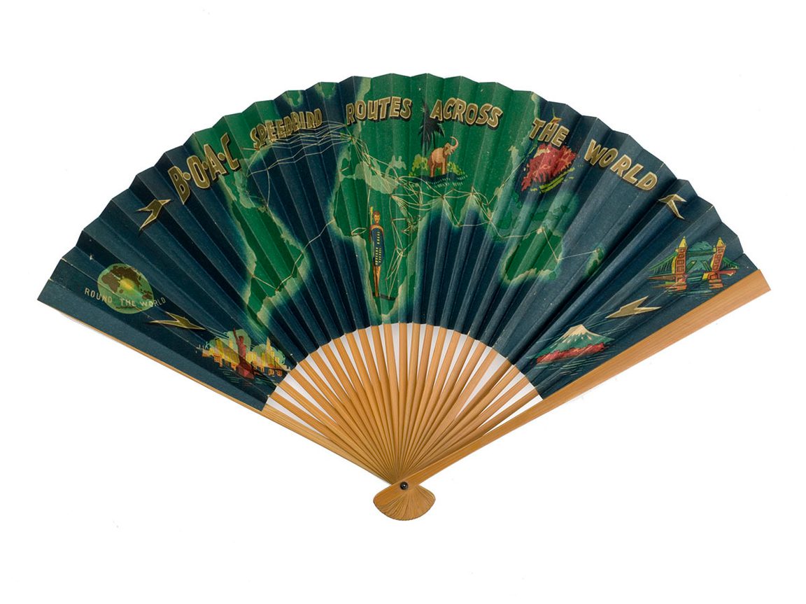 A colourful paper fan - 'BOAC Speedbird routes across the world' written in golden letters across a stylised map of the world, with illustrations such as an African elephant and the statue of liberty