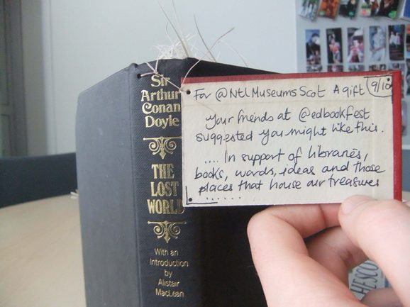 A tag on the mysterious book sculpture, reading, "For National Museums Scotland - a gift. Your friends at Edinburgh International Book Festival suggested you might like this. In support of libraries, books, words, idea and these places that house our treasures."