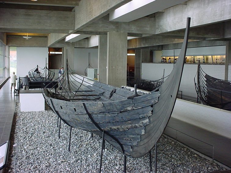 A Viking boat shown in a museum gallery space.