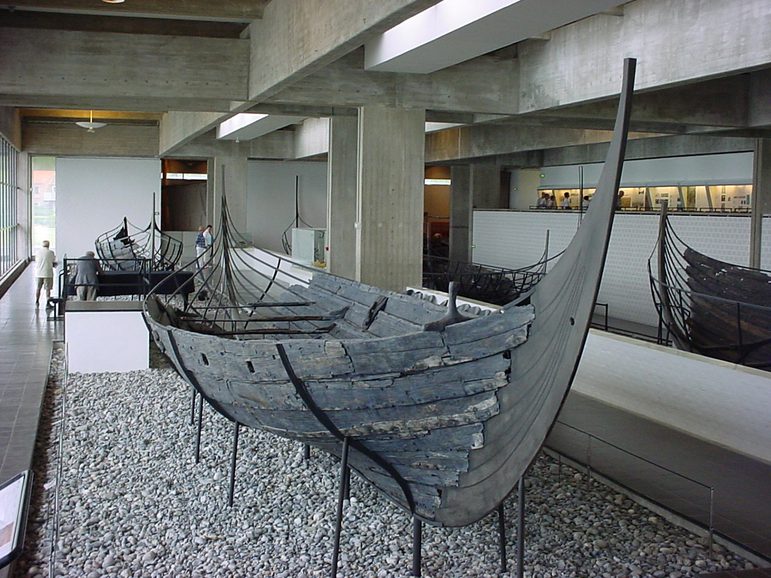 A Viking boat shown in a museum gallery space.