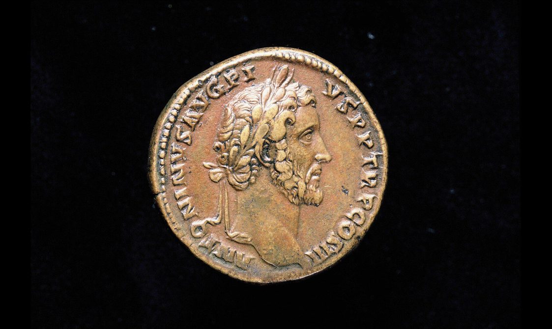 Rusted bronze coin depicting a man in profile with a thin chin-strap beard and curly hair.