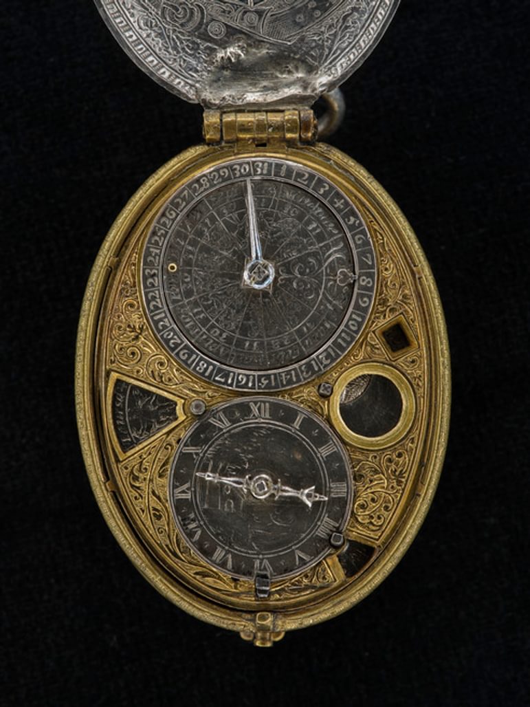 Close up of silver watch signed David Ramsay Scotus 13 showing clock face.