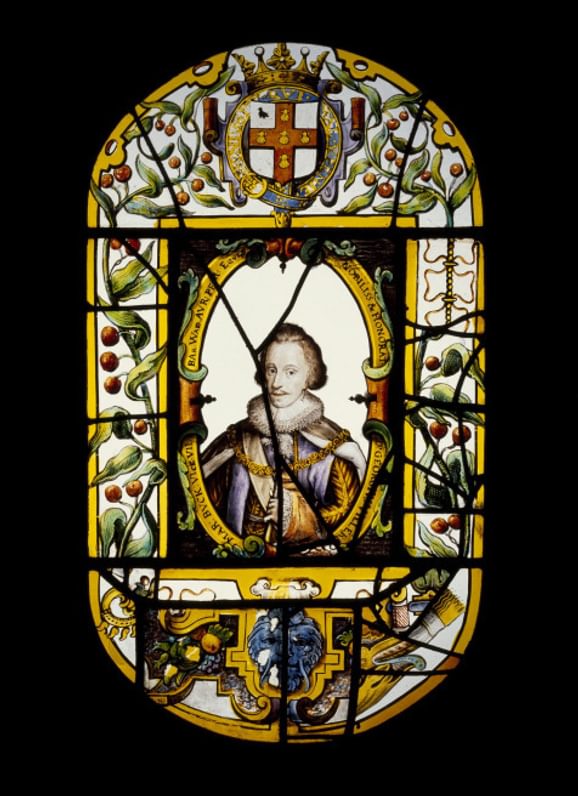 17th century oval glass panel of stained and painted glass with a rectangular panel in centre containing a half length portrait of George Villiers, Duke of Buckingham