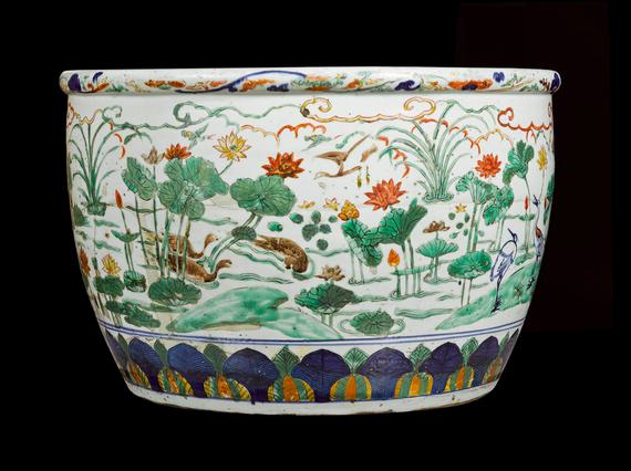 A large ceramic bowl with colourful decorative scenes of flowers and landscapes.