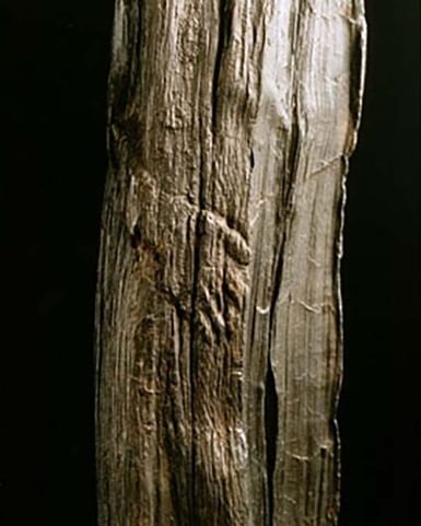 Wooden figure with right hand carved in.