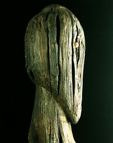 Wooden figure with 3D head carving.