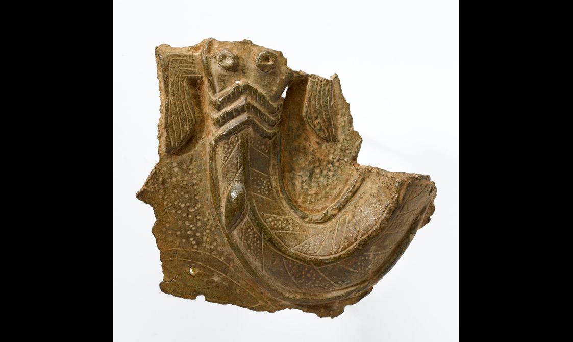 A fragment of a brass sculpture with decorative shapes
