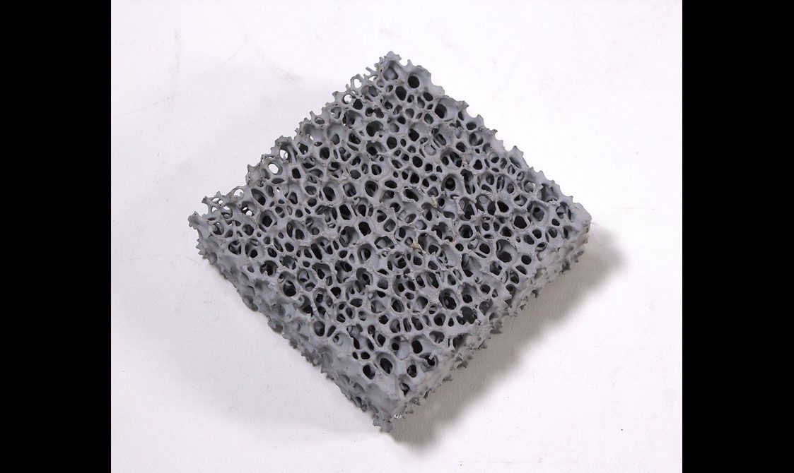 A square of grey silicon with holes through it.