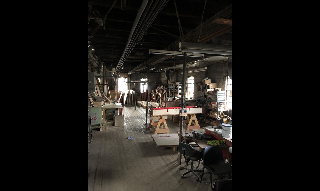 A workshop with benches and planks of wood. There are no staff pictured.