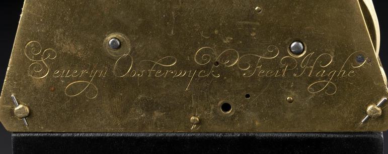 A gold plaque with the name Severyn Oosterwijck inscribed in a handwriting script.