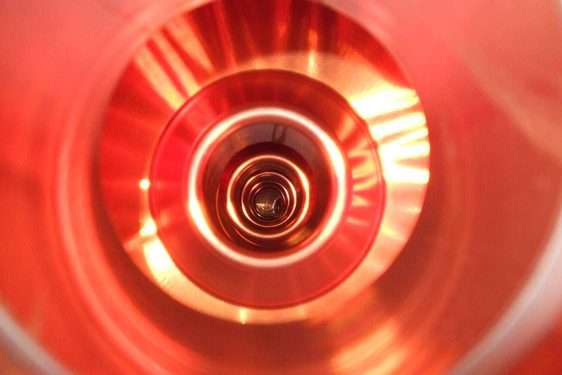 A colour photograph of the inside of a copper tub, showing concentric circular patterns.