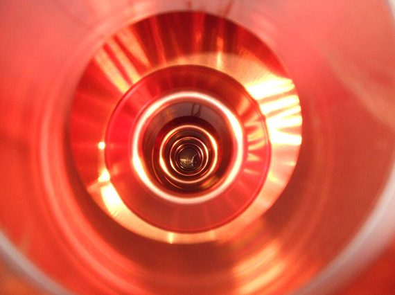 A colour photograph of the inside of a copper tub, showing concentric circular patterns.