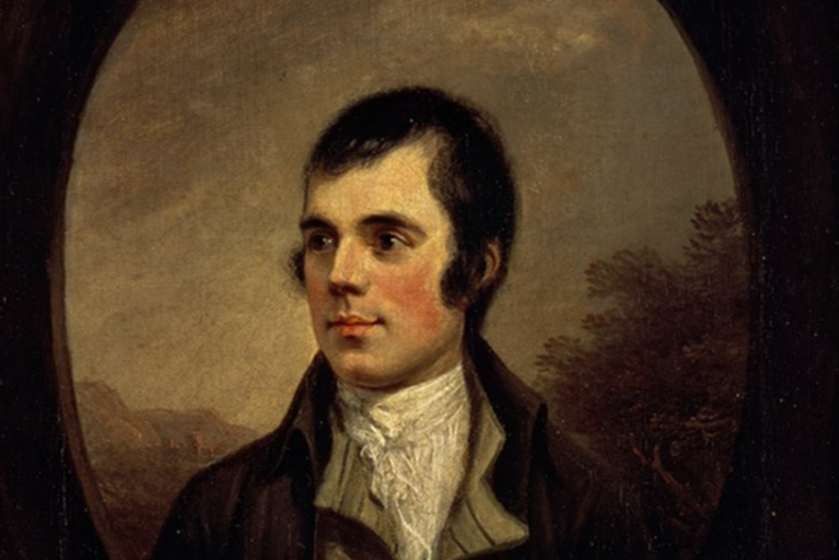A bust portrait of a man slightly turned to the left, wearing a dark coat with a white shirt against picturesque landscape in the background.