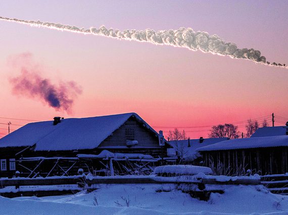 Snow covered houses separated by wooden fences, set against a light pink sky with a plume of smoke streaking through the sky