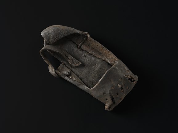 A child's black leather shoe.