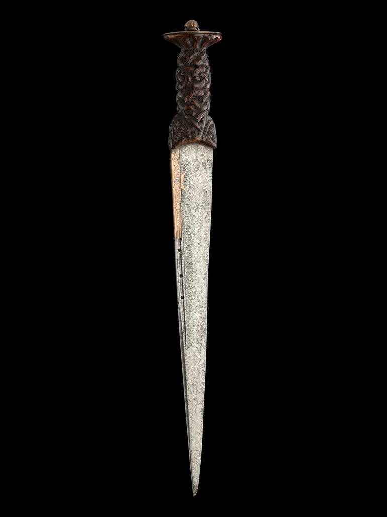 A traditional Highland dirk dagger with a metal blade and carved wooden hilt.
