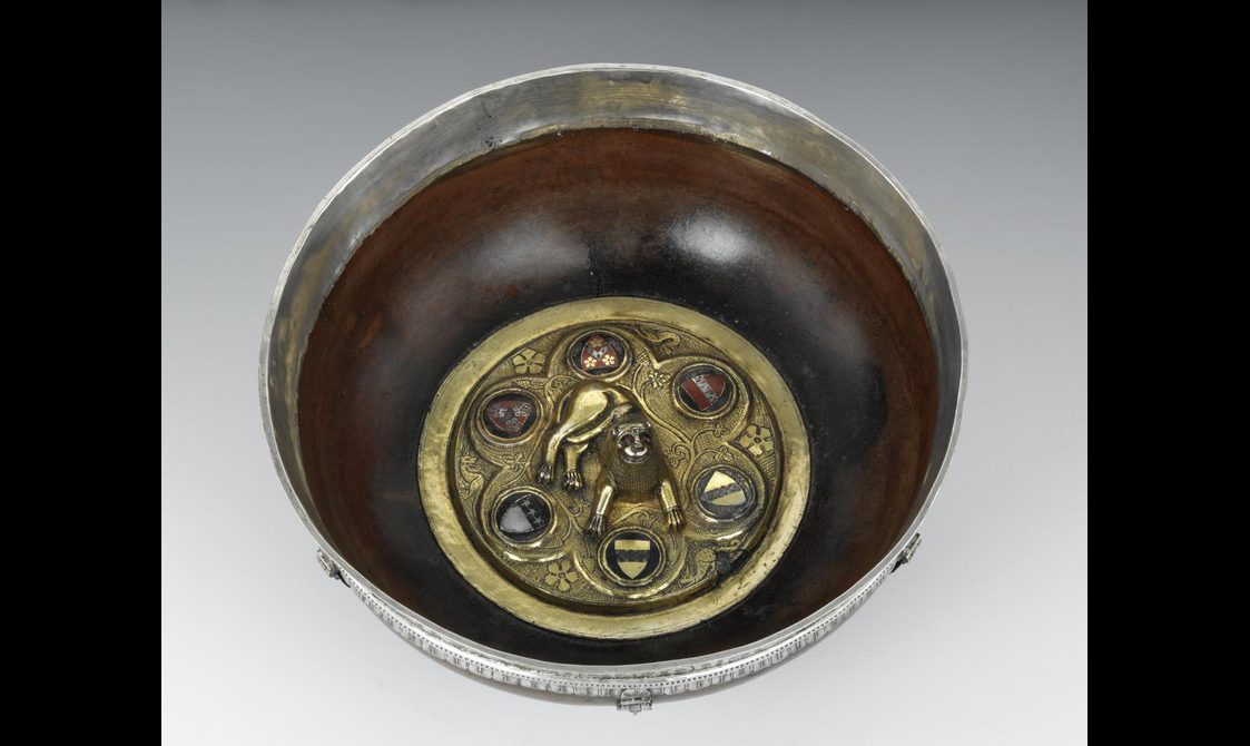 Circular wooden maple bowl with gold insert decorated with the image of a lion surrounded by 6 heraldic shields.