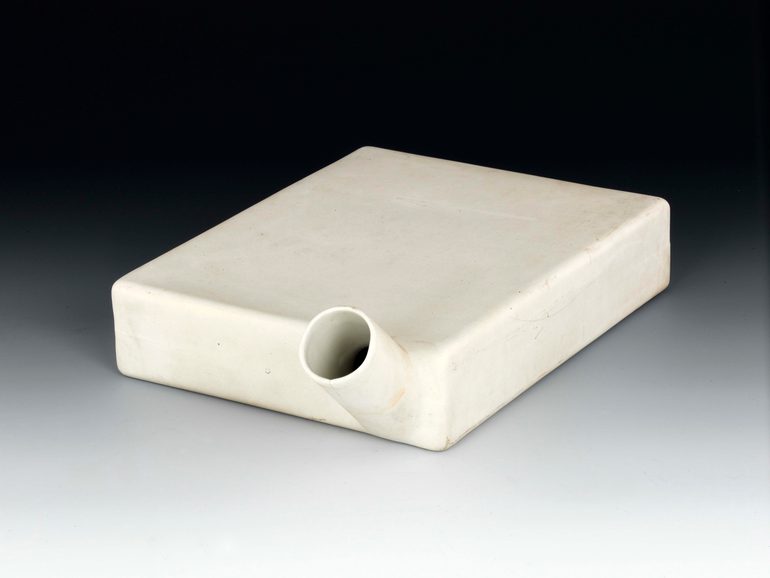 A low rectangular white ceramic box with a spout protruding from on side.