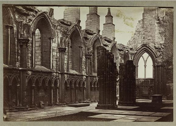 A black and white image of a partially ruined abbey.