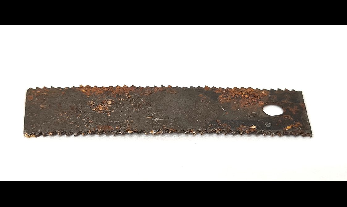 A long serrated hacksaw blade