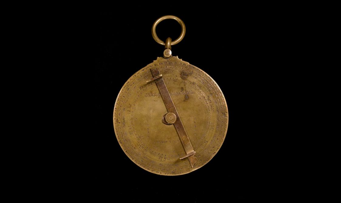 Back of bronze clock-looking model with one big dial.