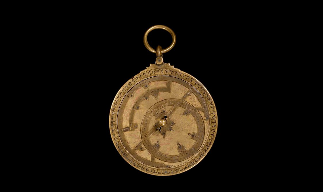 Bronze clock-looking model with ornate dials and decoration to represent the motions of the Sun and stars.