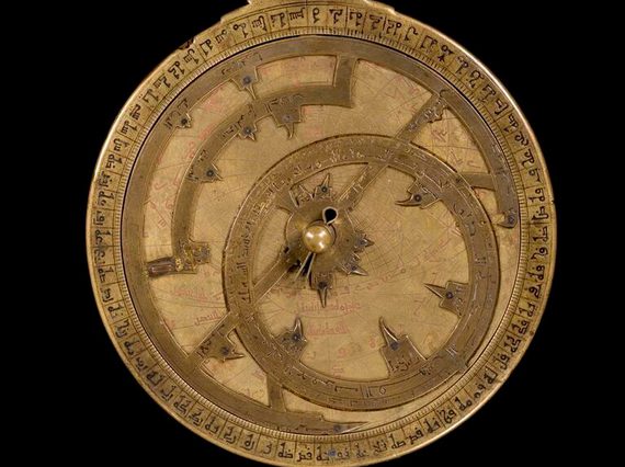 Bronze clock-looking model with ornate dials and decoration to represent the motions of the Sun and stars.