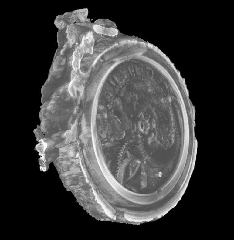 A black and white scan of a circular watch with a bumpy crust shape around the edge. The scan is at an angle. In the centre of the watch are markings showing the faint front workings of a watch including Roman numerals for the hours and a central hole where arms would have been fixed.