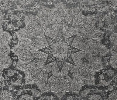 Detail of a silver object with a star pattern and fine details engraved all over the surface.