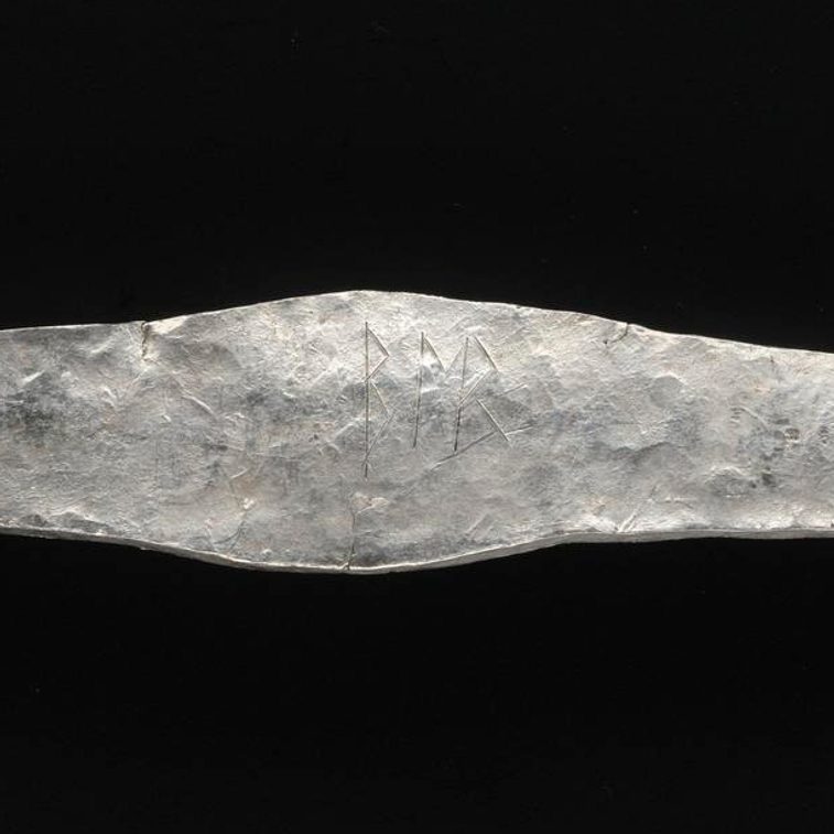 A close up of an inscription that reads BER.