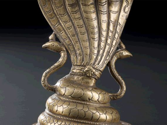 Figure of a seven-headed cobra in cast and chased brass.