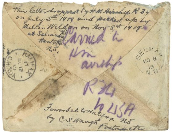 An aged yellowing envelope with handing writing and stamps all over its surface.