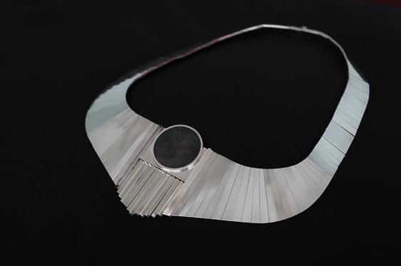 Silver link necklace with an oval stone.