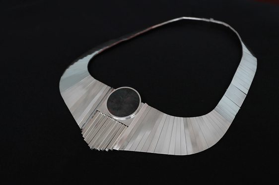 Silver link necklace with an oval stone.