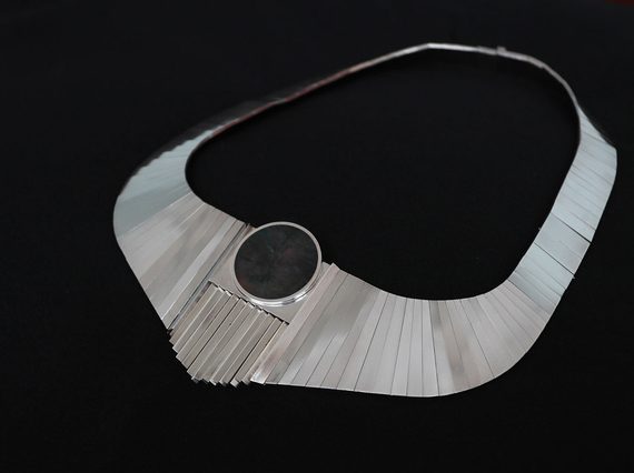Silver link necklace with an oval stone.