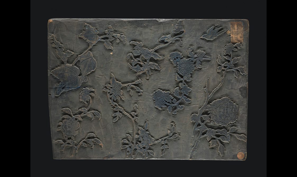 Wooden block with carved floral design