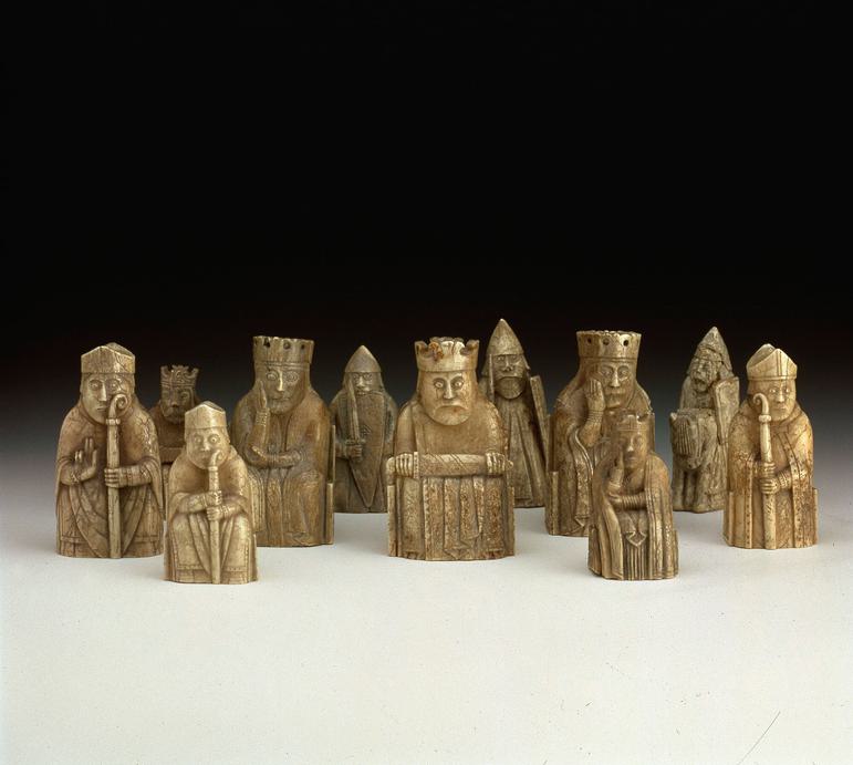 A group of chess pieces resembling kings, knights, and clergymen made from ivory