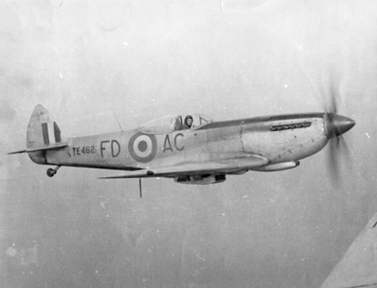 A black and white photograph of a pilot flying a spitfire aircraft.