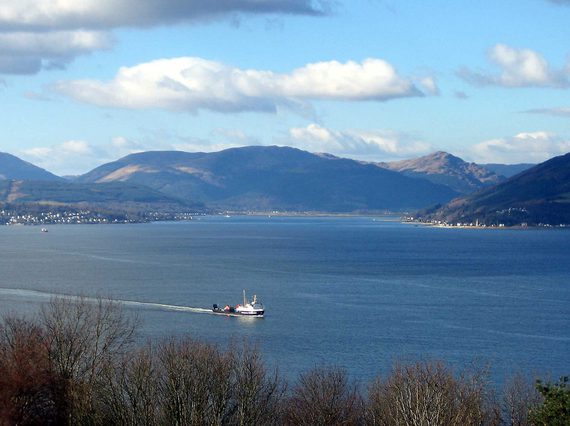 The Holy Loch near Dunoon. A large loch with mountains in the distance. A white ferry travels across the loch.