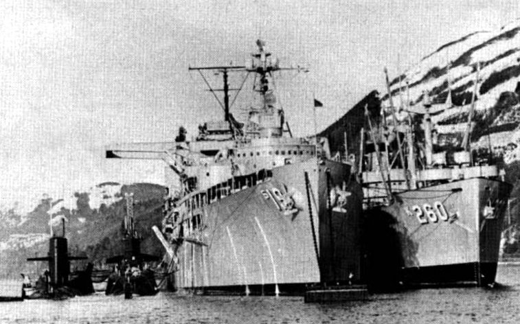 A black and white photograph of the USS Proteus (AS-19) and USS Betelgeuse (AK-260) at Holy Loch, Scotland.